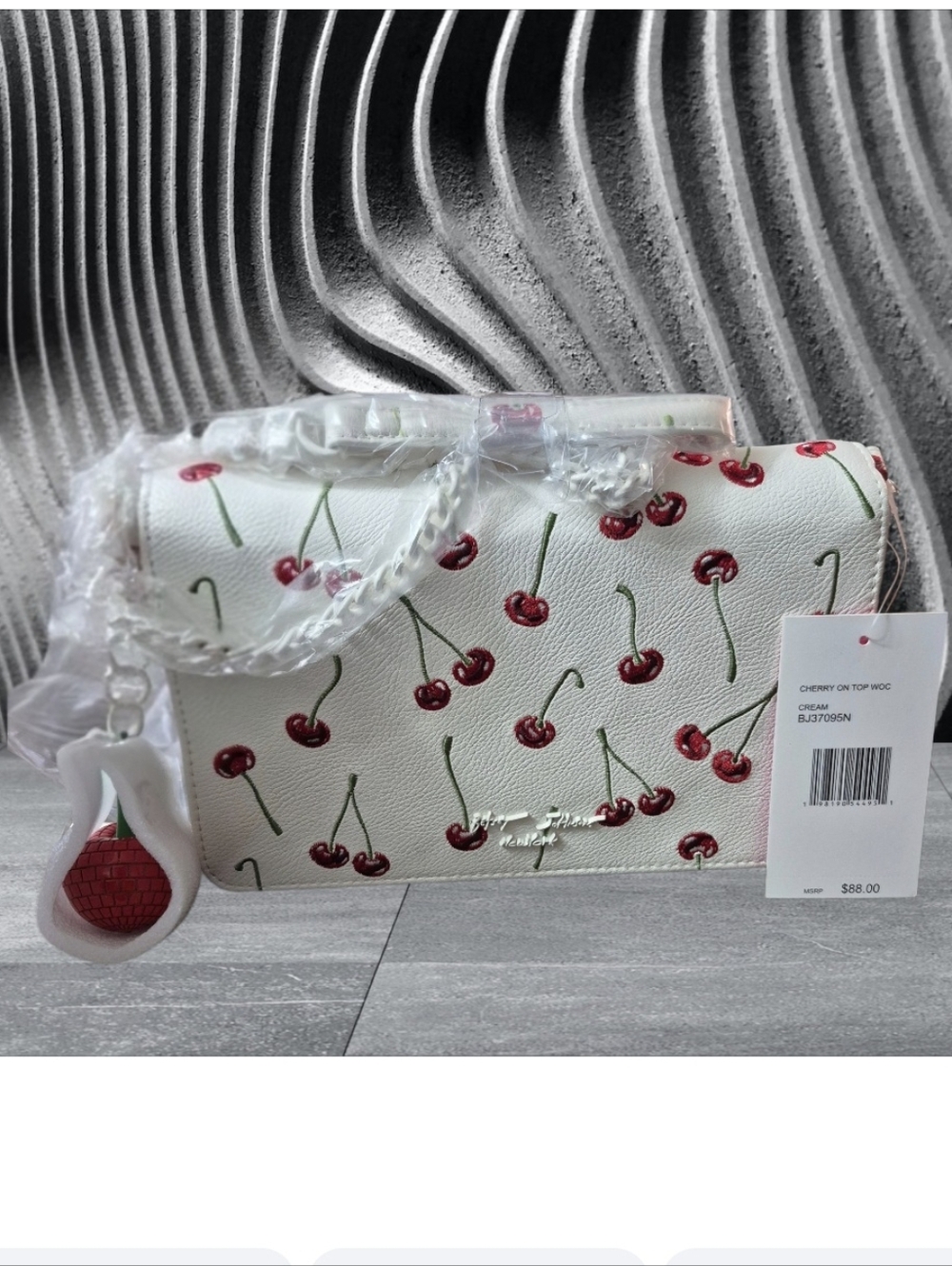Betsey Johnson Cherry On Top WOC (Wallet-on-Chain) crossbody bag in cream. 